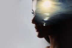 Psicanalisi e meditazione, concetto Profilo di una giovane donna e di un tramonto sopra l'oceano, la calma e la salute mentale fotografia stock Psicanalisi e meditazione, concetto Profilo di una giovane donna e di un tramonto sopra l'oceano, la calma e la salute mentale fotografia stock