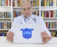 Psychotherapist holding Rorschach Test stock photo Psychotherapist holding Rorschach Test stock photo