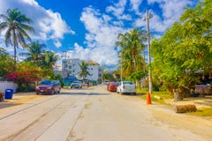 Puerto Morelos, Mexico - January 10, 2018: Outdoor view of some houses with many cars parked in the street of Puerto Stock Photos Puerto Morelos, Mexico - January 10, 2018: Outdoor view of some houses with many cars parked in the street of Puerto Stock Photos