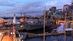 Pulsating city at harbor with navy ship by dusk royalty free stock photography Pulsating city at harbor with navy ship by dusk royalty free stock photography