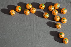 Pumpkin candy balls with shadows on slate. stock photos Pumpkin candy balls with shadows on slate. stock photos