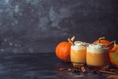 Pumpkin Latte Drink. Autumn Coffee With Spicy Pumpkin Flavor And Cream On A Dark Background. Seasonal Fall Drinks For Halloween Royalty Free Stock Photography