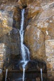 Pure mineral drinking water flowing from the natural mountain source Royalty Free Stock Photo Pure mineral drinking water flowing from the natural mountain source Royalty Free Stock Photo