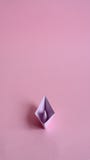 Purple paper boat on a light pink background. royalty free stock photos Purple paper boat on a light pink background. royalty free stock photos