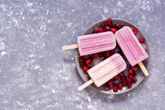 Purple - pink ice cream with berries on a gray background, top view. Frozen berry yogurt. Copy space,flat lay Stock Image Purple - pink ice cream with berries on a gray background, top view. Frozen berry yogurt. Copy space,flat lay Stock Image