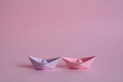 Purple and rose paper boats on pastel pink stock photos Purple and rose paper boats on pastel pink stock photos