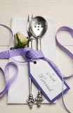 Purple and white shabby chic wedding table setting. Vertical.