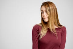 Puzzled woman keeps lips pressed, has frustrated facial expression, frowns face in displeasure, being deep in thoughts royalty free stock image Puzzled woman keeps lips pressed, has frustrated facial expression, frowns face in displeasure, being deep in thoughts royalty free stock image