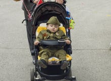 PYATIGORSK, RUSSIA - MAY 09, 2017: A little boy in uniform for the day of victory in baby stroller stock photography PYATIGORSK, RUSSIA - MAY 09, 2017: A little boy in uniform for the day of victory in baby stroller stock photography