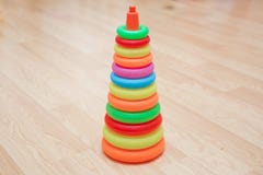 Pyramid build from colored wooden rings with a clown head on top. Toy for babies and toddlers to joyfully learn stock photo Pyramid build from colored wooden rings with a clown head on top. Toy for babies and toddlers to joyfully learn stock photo