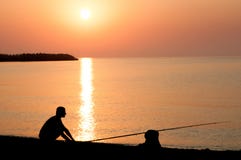 Pêche au coucher du soleil photographie stock Pêche au coucher du soleil photographie stock