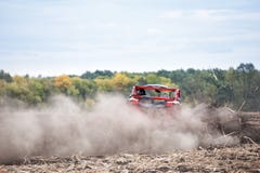 Quad bike is driving away into dusty clubs Stock Photo Quad bike is driving away into dusty clubs Stock Photo