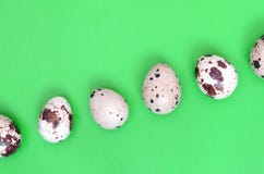 Quail eggs on a light green surface, top view, empty place for t stock photo Quail eggs on a light green surface, top view, empty place for t stock photo