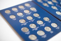 Close-up view of collection of Quarter dollars 25 cents coins in album - numismatic collection stock photo Close-up view of collection of Quarter dollars 25 cents coins in album - numismatic collection stock photo