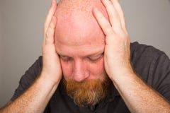 quiet-time-man-bald-beard-holding-his-hands-over-his-ears-47605700.jpg