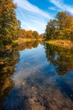 A quiet tired river flows through the autumn sunny forest 2 stock images A quiet tired river flows through the autumn sunny forest 2 stock images