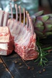 Rack of lamb , raw meat with bone on rustic kitchen table at wooden background, side view stock photography Rack of lamb , raw meat with bone on rustic kitchen table at wooden background, side view stock photography