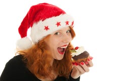 Ragazza di Natale che mangia dolce immagini stock Ragazza di Natale che mangia dolce immagini stock