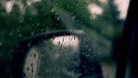 Rain drops flow down on a car window glass, rainy day stock video footage Rain drops flow down on a car window glass, rainy day stock video footage