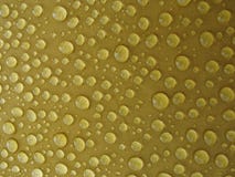 Rain drops at yellow surface. Stock Photography Rain drops at yellow surface. Stock Photography