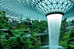 Rain Vortex, the world`s tallest indoor waterfall at Jewel Changi Airport. Green forest in the mall and skytrain. Iconic landmark royalty free stock images Rain Vortex, the world`s tallest indoor waterfall at Jewel Changi Airport. Green forest in the mall and skytrain. Iconic landmark royalty free stock images