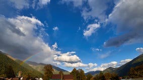 Rainbow on a background of mountains, sky and clouds stock photo Rainbow on a background of mountains, sky and clouds stock photo