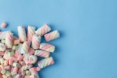 Rainbow color of spiral marshmallows on blue background Stock Photos Rainbow color of spiral marshmallows on blue background Stock Photos