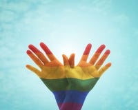 Rainbow flag pattern on people`s hand in butterfly shape for Zero discrimination day concept