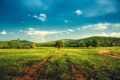 Rainbow over fields and trees on a farm on the edge of Lake stock images Rainbow over fields and trees on a farm on the edge of Lake stock images