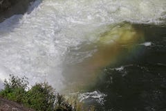 Rainbow water falls. Rainbow over waterfall in dam. Colorful rainbow in splash water. Water falls from high and crashes with multi stock photo Rainbow water falls. Rainbow over waterfall in dam. Colorful rainbow in splash water. Water falls from high and crashes with multi stock photo