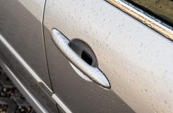 Raindrops on a silver car on the side front door, visible handle. royalty free stock images Raindrops on a silver car on the side front door, visible handle. royalty free stock images