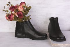 Ramo de Rose y zapatos de cuero negros en el fondo de madera blanco del grunge imagenes de archivo Ramo de Rose y zapatos de cuero negros en el fondo de madera blanco del grunge imagenes de archivo