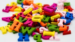 Randomly scattered colorful wooden letters on a white background. Stock Photo Randomly scattered colorful wooden letters on a white background. Stock Photo
