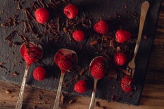 Raspberries and chocolate on a kitchen table stock photography Raspberries and chocolate on a kitchen table stock photography
