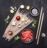 Raw buckwheat noodles, pickled ginger, onion, chopped pepper, chopsticks, soy sauce, ingredients for cooking Asian food border o royalty free stock photo Raw buckwheat noodles, pickled ginger, onion, chopped pepper, chopsticks, soy sauce, ingredients for cooking Asian food border o royalty free stock photo