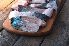 Raw fish with spices on a wooden board. stock photo Raw fish with spices on a wooden board. stock photo