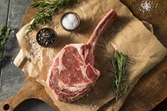 Raw Red Grass Fed Tomahawk Steaks stock image Raw Red Grass Fed Tomahawk Steaks stock image