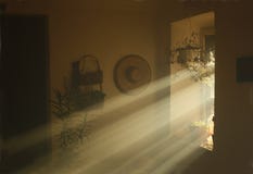 Rays of light coming from a window in an old country house.