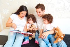 Reading a book with your family. A happy family. Children Twins stock photography Reading a book with your family. A happy family. Children Twins stock photography