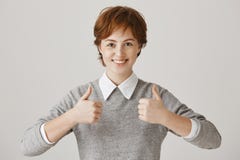 Ready to be super productive today. Positive good-looking redhead woman with freckles smiling broadly at camera while stock photography Ready to be super productive today. Positive good-looking redhead woman with freckles smiling broadly at camera while stock photography