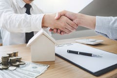 Real estate broker agent and customer shaking hands after signin stock image Real estate broker agent and customer shaking hands after signin stock image