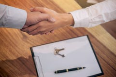 Real estate broker agent and customer shaking hands after signing contract documents for realty purchase, Bank employees royalty free stock photography Real estate broker agent and customer shaking hands after signing contract documents for realty purchase, Bank employees royalty free stock photography