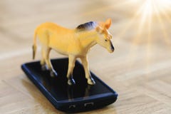 Real horse model toy in action of running on surface of device. stock photos Real horse model toy in action of running on surface of device. stock photos