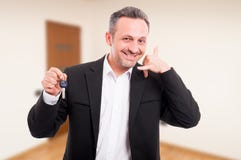 Realtor man is holding house keys Stock Photos Realtor man is holding house keys Stock Photos