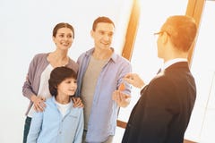 Realtor is giving keys to family in new apartment with cardboard boxes. stock image Realtor is giving keys to family in new apartment with cardboard boxes. stock image