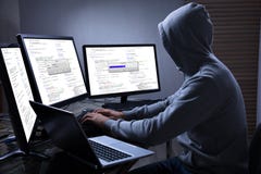 Hacker Using Multiple Computers For Stealing Data royalty free stock photos Hacker Using Multiple Computers For Stealing Data royalty free stock photos