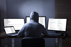 Hacker Using Multiple Computers For Stealing Data stock photos Hacker Using Multiple Computers For Stealing Data stock photos