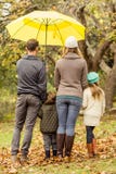 Rear View Of Young Family Under Umbrella Stock Photography Rear View Of Young Family Under Umbrella Stock Photography