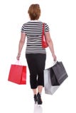 Rear view of a woman carrying shopping bags isolated. Stock Photos Rear view of a woman carrying shopping bags isolated. Stock Photos