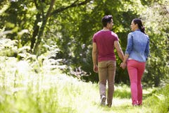 Rear View Of Young Couple Walking In Summer Countryside Stock Photography Rear View Of Young Couple Walking In Summer Countryside Stock Photography